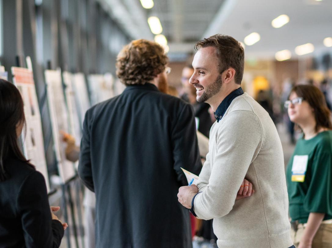 Students present projects at a research symposium.